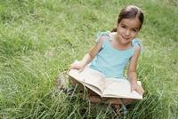 Little reader in grass
